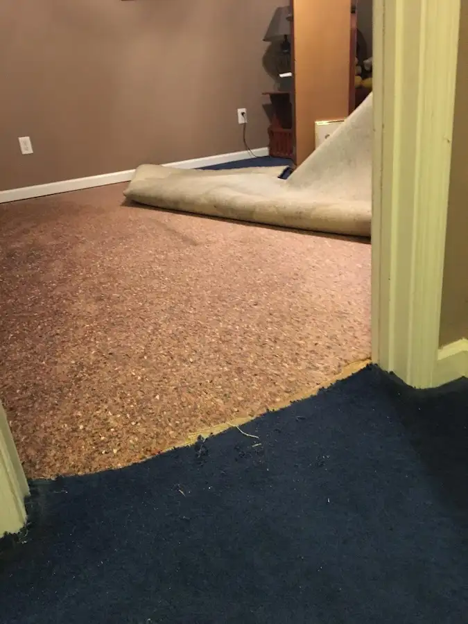 Carpet pad removal revealing water damage during Water Mitigation Services in Florin